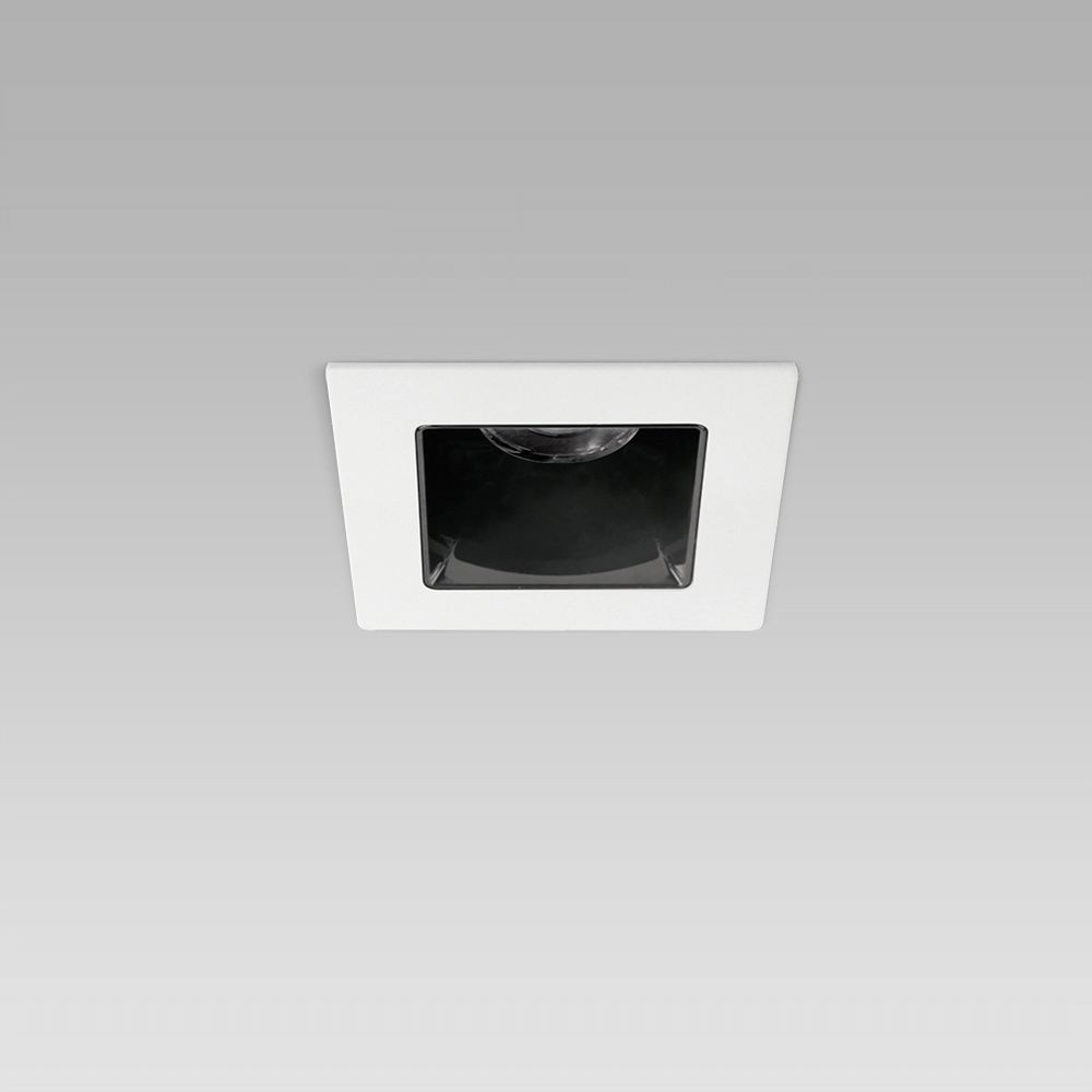 Squared recessed ceiling downlight for interior lighting with protruding frame and black optic