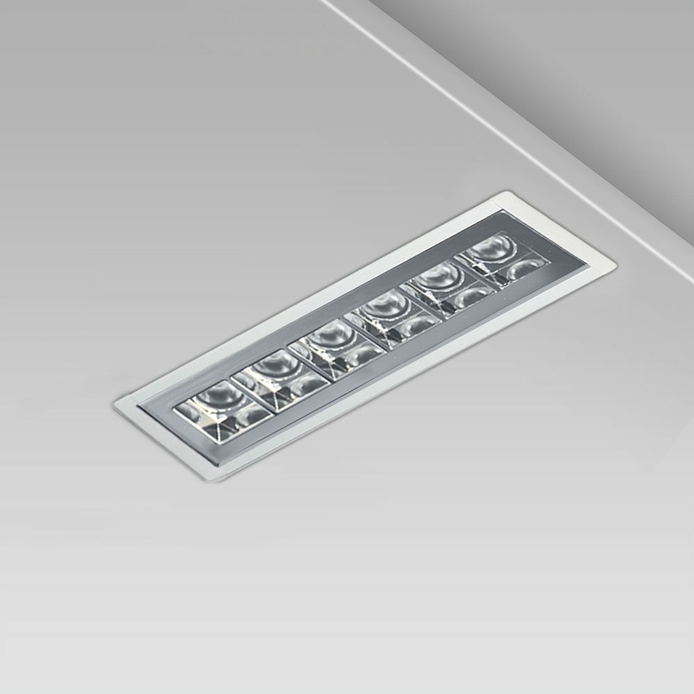 Linear ceiling recessed downlight with a minimalist design for indoor lighting, with protruding frame and UGR<16 metalized square optic